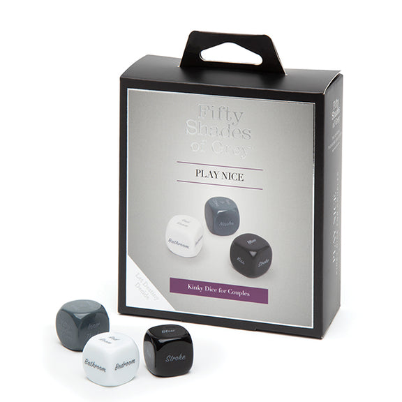 The Fifty Shades of Grey Kinky Dice sitting out in front of the packaging that they come in. | Kinkly Shop