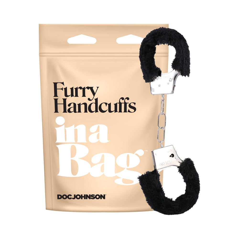 The furry handcuffs shown next to the bag that they come in. | Kinkly Shop