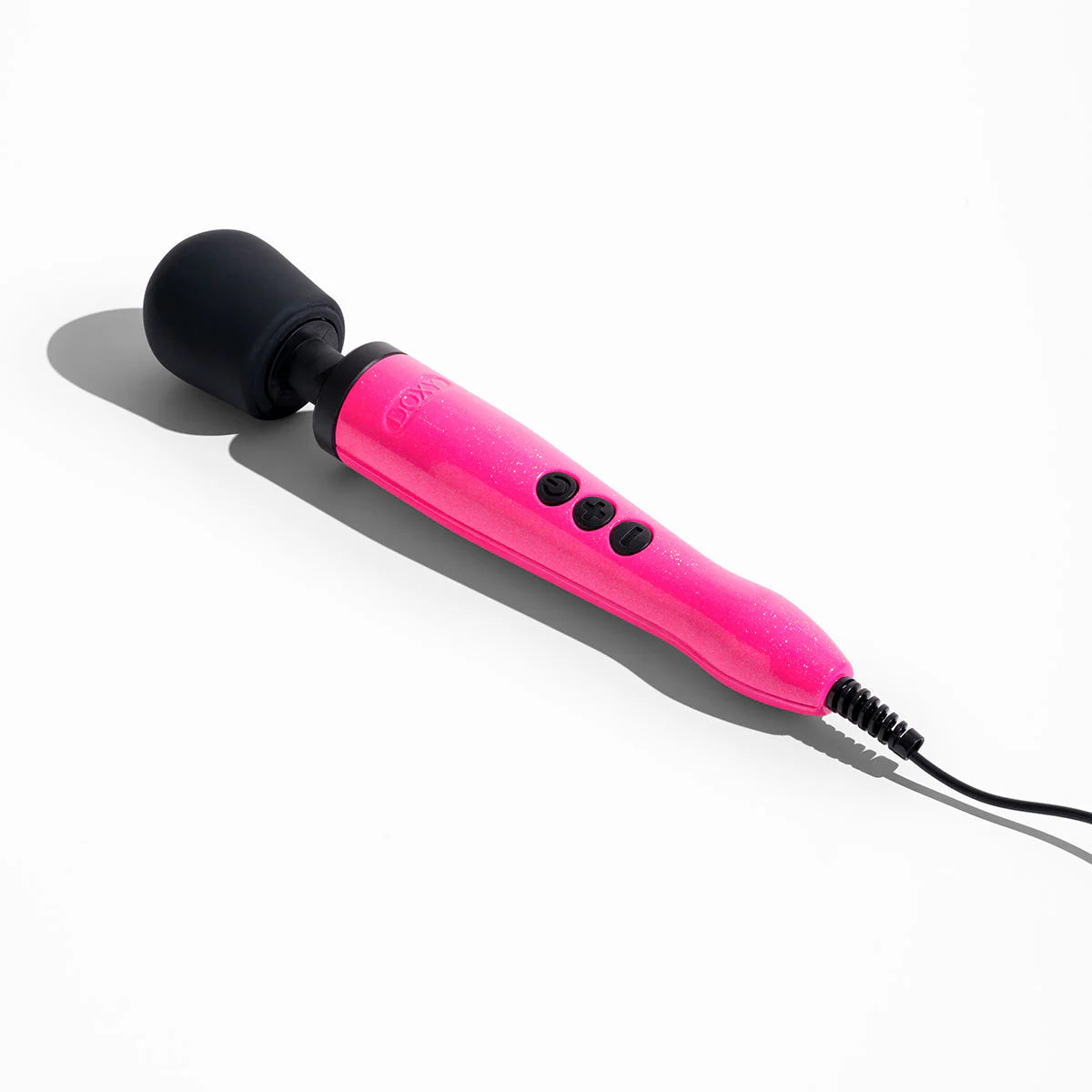 The Doxy Die Cast rests on a flat surface. Hard light shines on it, showcasing the sparkly colors of the Hot Pink design. | Kinkly Shop