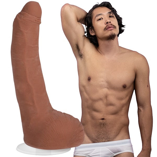Leo Vice is staring seductively into the camera while shirtless with their underwear briefs pulled pretty far down. The Signature Cocks - Leo Vice dildo is shown next to the porn star. | Kinkly Shop