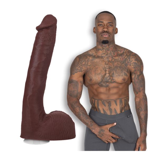 Pressure the porn star is shirtless and staring at the camera. He's wearing boxer briefs. The Signature Cocks - Pressure dildo is shown right next to Pressure. | Kinkly Shop