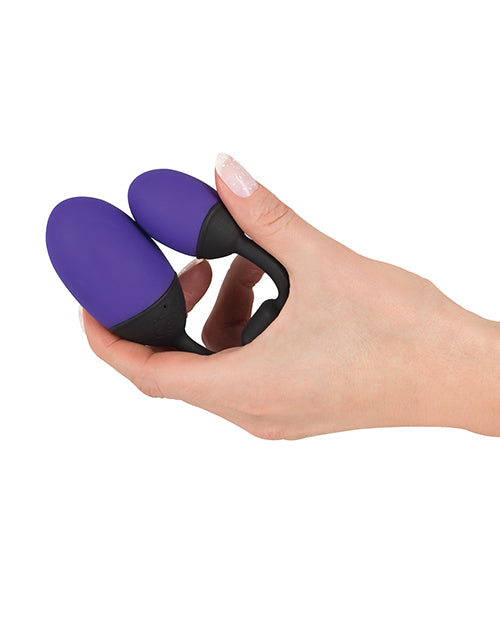 A hand holds the GoGasm Vibrating Pussy & Ass Balls. The balls fold up easily until they're touching one another. The toy fits comfortably in the U-shape between the person's pointer and thumb fingers. | Kinkly Shop