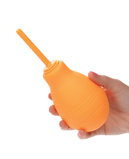 A hand holds the Cheeky One Way Flow Enema Bulb. The bulb seems to be wide in their hands but it looks very squishy. | Kinkly Shop