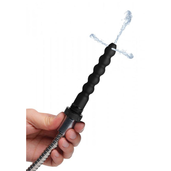 A person is holding the enema tip of the CleanStream Discreet Shower Head with Silicone Enema Nozzle. Water is pouring through the tip of the enema probe squirting from the top and both of the sides. | Kinkly Shop