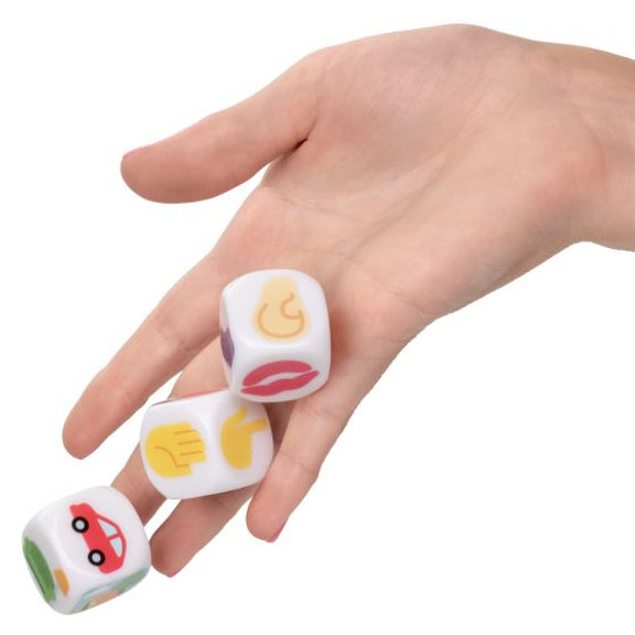 A hand is rolling the Emojigasm Dice. The dice look larger than traditional game dice to make it easier to see the pictures on the sides. | Kinkly Shop