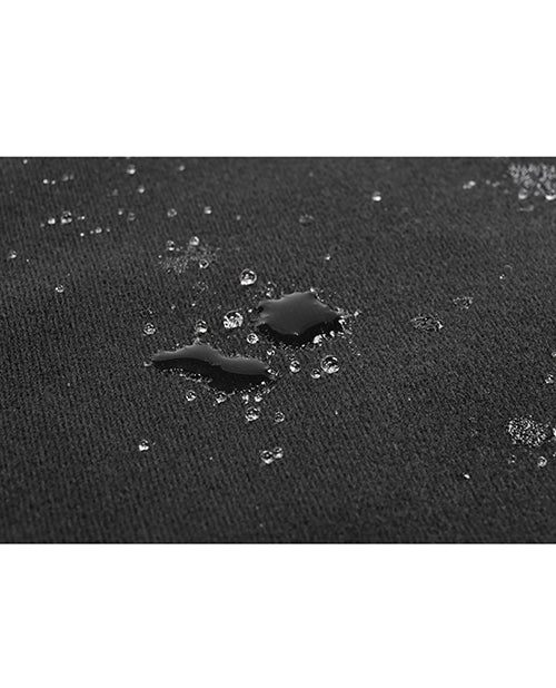 A few drops of liquid shown on the Pivot Protector. It showcases how the liquid pools on the blanket and doesn't absorb or go onto the furniture underneath the blanket. | Kinkly Shop