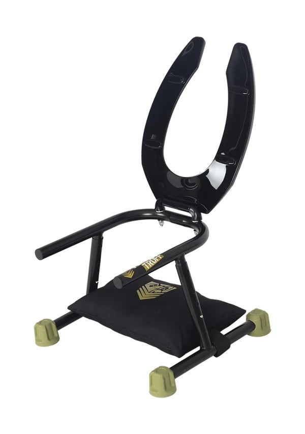 The Fort Troff Trench Rider set up with the included pillow while the toilet seat seat is lifted up, showcasing the metal frame underneath it | Kinkly Shop