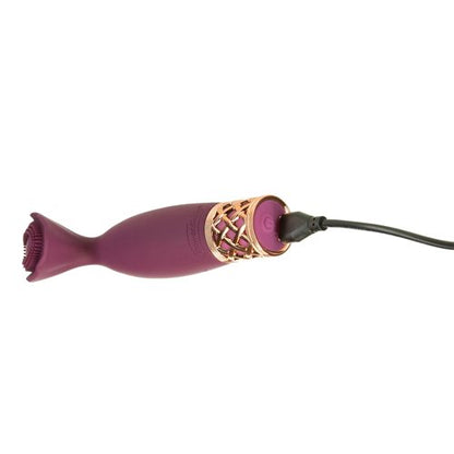 The charging cable plugged into the base of the Pillow Talk Secrets Passion. The power button is illuminated as the vibrator charges. | Kinkly Shop
