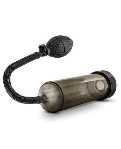 Close-up of the textured tube running out of the top of the Blush Performance VX101. It has a crinkled, bendable design with a textured air pump for easier gripping. There are measurement lines on the penis pump chamber. | Kinkly Shop