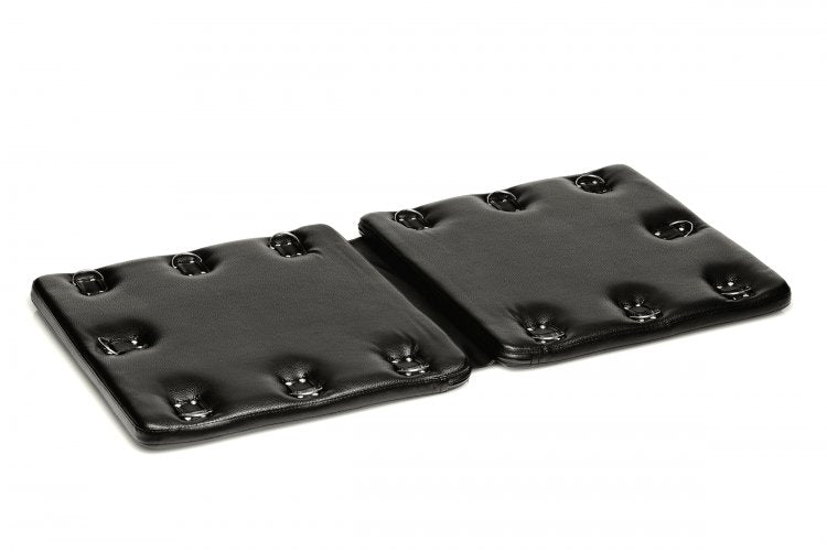 The Strict Bondage Board resting in front of a plain white background. It looks like two sturdy squares attached together by a flexible material that allows the two squares to fold together for storage. | Kinkly Shop