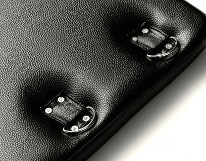 Close-up on the D-rings built into the Strict Bondage Board itself. They are held in place by four rivets and a full strap of fabric that allows for movement of the D-rings. | Kinkly Shop