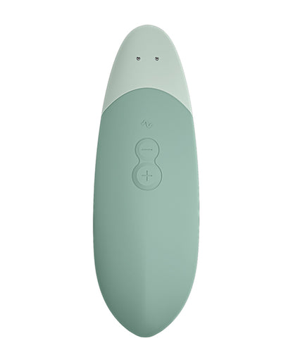 Close-up of the Womanizer Vibe's buttons on the handle of the Womanizer Vibe. There's a plus sign, minus sign, and a button for pattern/AutoPilot control. | Kinkly Shop