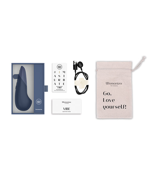 Everything that's included with th Womanizer Vibe. There's the cotton drawstring bag, the charging cable, a sticker, a manual, and the Womanizer Vibe itself. | Kinkly Shop