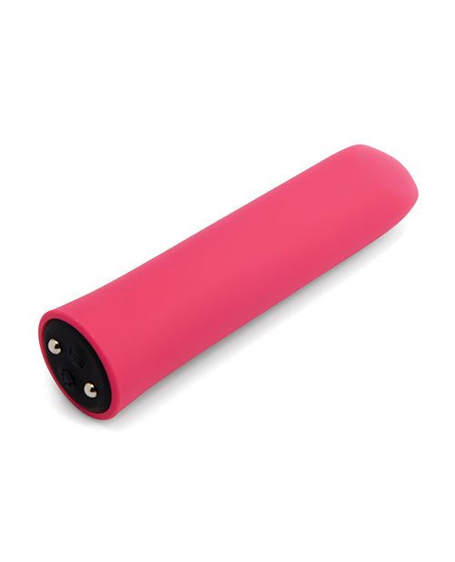 The Nubii: Sunni Warming Bullet laying on its side, showcasing the buttons on the base that rest right next to magnetic charging ports where the charger attaches. | Kinkly Shop