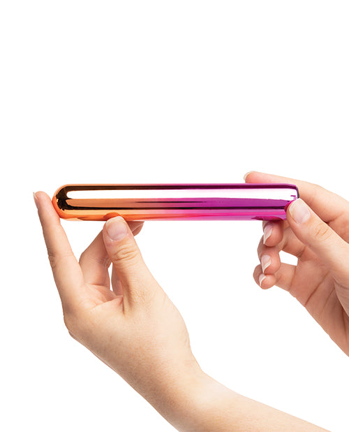 Two hands hold the slender vibrator of the Aluminum Rumba. It is narrower than two fingers' width, but it's much longer than a single finger. | Kinkly Shop