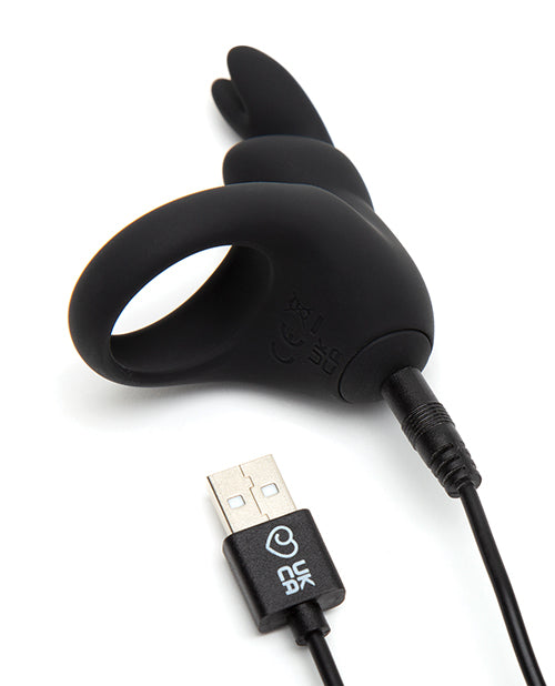 The Happy Rabbit Rechargeable Cock Ring with a close-up on the base of the rabbit vibrator as the charging cable is plugged into the base. The other end of the charging cable has a USB plug. | Kinkly Shop