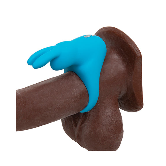 The Happy Rabbit Rechargeable Cock Ring in Blue wrapped around the base of a dildo, showcasing how the rabbit and its rabbit ear clitoral arms will surround the clit. | Kinkly Shop