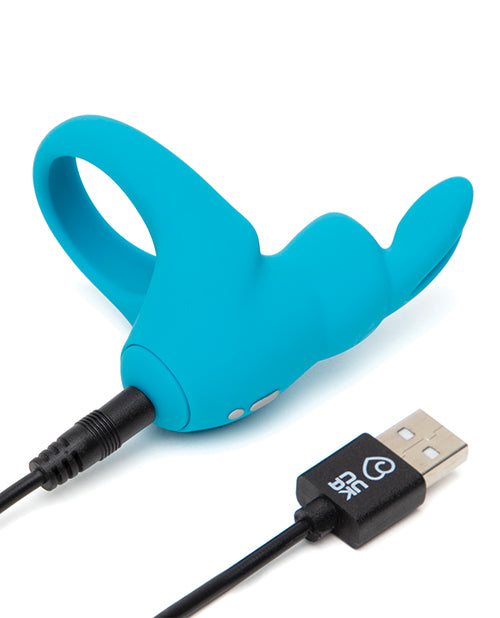 The Happy Rabbit Rechargeable Cock Ring plugged into its charging cable, showcasing how the toy plugs in to charge. | Kinkly Shop