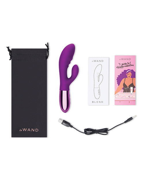 Everything included with the Le Wand Blend vibrator. This includes the black drawstring bag, the instruction manual, a promotional booklet, a charging cable, and the vibrator. | Kinkly Shop