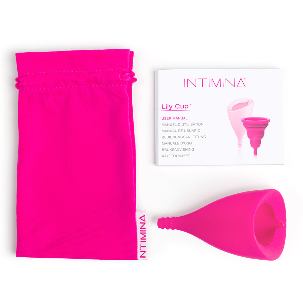The Intimina Lily Cup B shown with everything it comes with including the drawstring bag and the instruction booklet. | Kinkly shop
