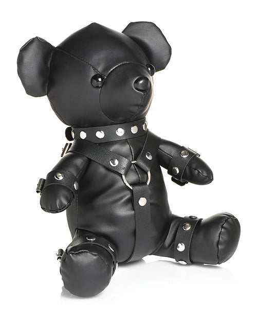 Side view of the Master Series Gimp Bear. The bear is wearing a collar, wrist cuffs, ankle cuffs, and a chest harness. | Kinkly Shop