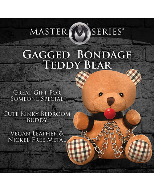 The Master Series Gagged Teddy Bear with text all around the photo. The text reads: "Gagged bondage teddy bear. Great gift for someone special. Cute kinky bedroom buddy. Vegan leather & nickel-free metal." | Kinkly Shop