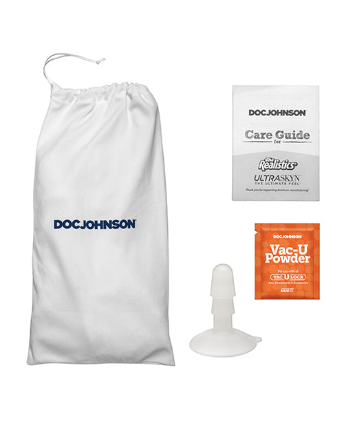 Everything included with the Signature Cocks - The Flesh Mechanic dildo. There's a white drawstring bag, the Care Guide, the Vac-U-Lock suction cup attachment, and a sample of Vac-U-Lock powder. | Kinkly Shop