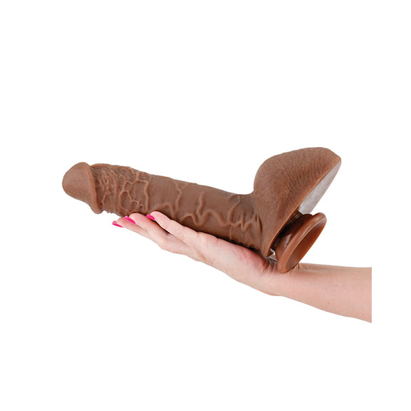 An arm and hand is outstretched. The Shane Diesel 10" Dual Density is resting on their palm, extending back onto their forearm. It looks like an extremely thick dildo that's much longer than their hand and probably thicker than all four of their fingers put together. | Kinkly Shop