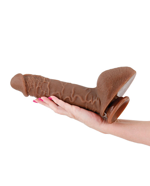 An arm and hand is outstretched. The Shane Diesel 10" Dual Density is resting on their palm, extending back onto their forearm. It looks like an extremely thick dildo that's much longer than their hand and probably thicker than all four of their fingers put together. | Kinkly Shop