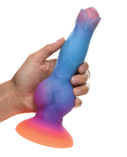 A hand holds the Creature Cocks Space Cock. The knot at the base looks very thick, but the shaft itself looks somewhat close to a biological penis. | Kinkly Shop