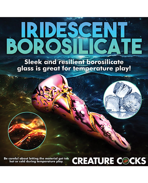 The Creature Cocks Enchantress shown next to ice cubes and lava. The text reads: "Iridescent borosilicate. Sleek and resilient borosilicate glass is great for temperature play! Be careful about letting the material get too hot or too cold during temperature play." | Kinkly Shop