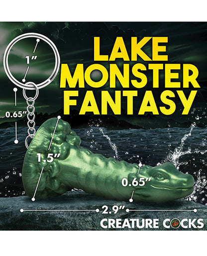 Creature Cocks Cockness Monster Key Chain with measurements superimposed on top of it. The keychain has a 1.5" diameter base, is 2.9" in total length, and has a diameter of 0.65" o the dragon shaft. The chain connecting it to the keychain loop is 0.65" in length. | Kinkly Shop