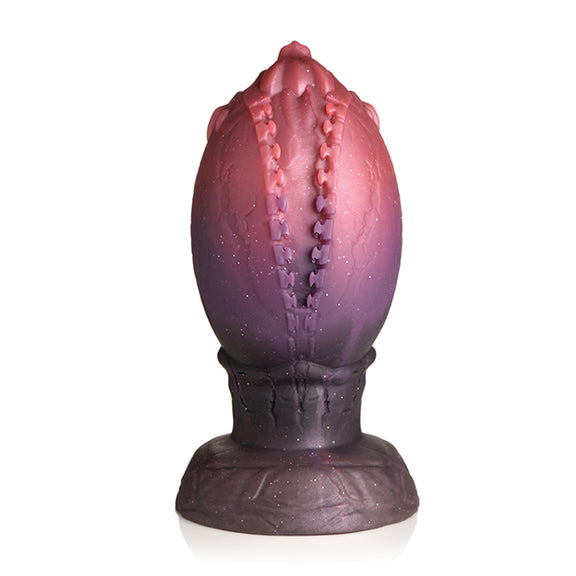 The Creature Cocks Dragon Hatch sits in front of a plain white background. It looks like it has a zipper through the center of the plug where the egg is "hatching". | Kinkly Shop