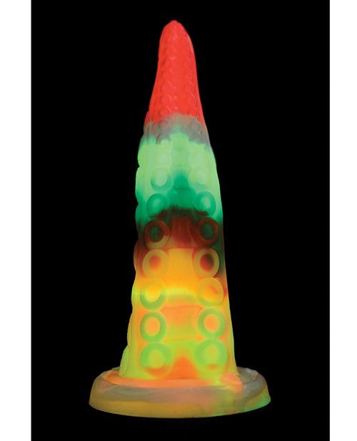 The Creature Cocks Luminoctopus shown in a black room, showcasing all of the colors of its glow in the dark functionality. | Kinkly Shop