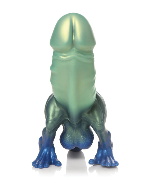 Close-up on the tip of the Creature Cocks Jurassic Cock dildo. It has a standard, realistic head at the top but the bottom has dinosaur balls, feet, and a tail. | Kinkly Shop