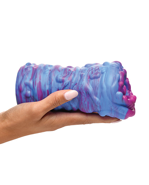 An outstretched palm has the Creature Cocks Cyclone Alien resting on top of it. The stroker is slightly longer than the person's outstretched palm. The stroker has light texturing on the outside of the stroker to make it easier to grip. | Kinkly Shop
