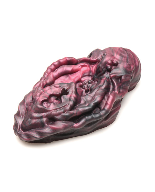 Side view of the Creature Cocks Xeno Grinder. The toy is oval-shaped and particularly flat. It doesn't look like very many spots on it protrude vertically very far. | Kinkly Shop