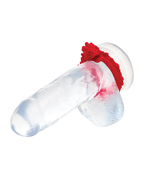 The Creature Cocks Rise of the Dragon shown wrapped underneath the testicles of a clear realistic dildo. It can be worn under the testicles or just at the base of the shaft. | Kinkly Shop