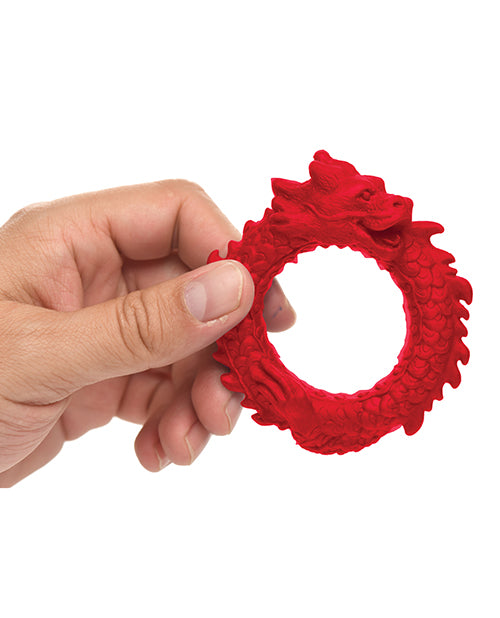 A hand holds the Creature Cocks Rise of the Dragon. The ring looks surprisingly formidable considering how small most cock rings look. You can easily see all of the detailing of the dragon design. | Kinkly Shop