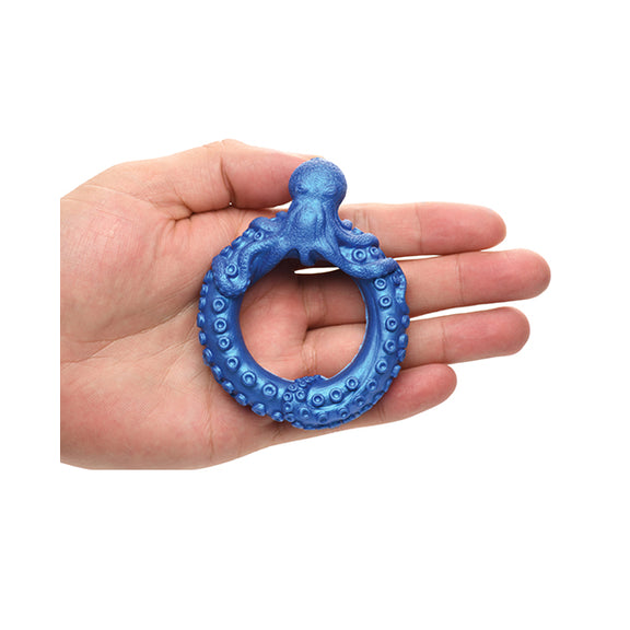 The Creature Cocks Poseidon's Octo rests on top of a person's outstretched palm. The ring looks substantial, but not gigantic, on their hand. | Kinkly Shop
