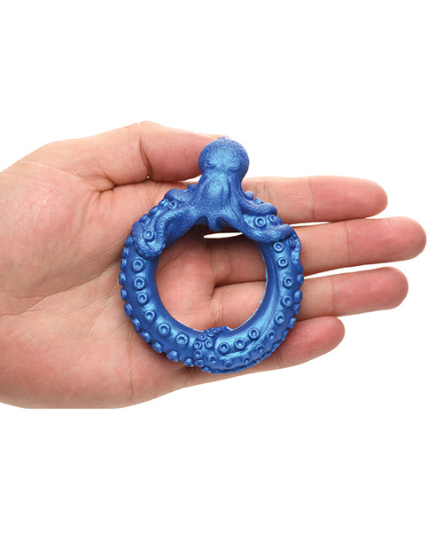 The Creature Cocks Poseidon's Octo rests on top of a person's outstretched palm. The ring looks substantial, but not gigantic, on their hand. | Kinkly Shop