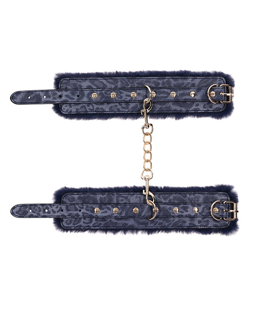 Both Sportsheets Cougar Fur Wrist Cuffs laid flat. The gold hardware offers a beautiful contrast from the material. | Kinkly Shop