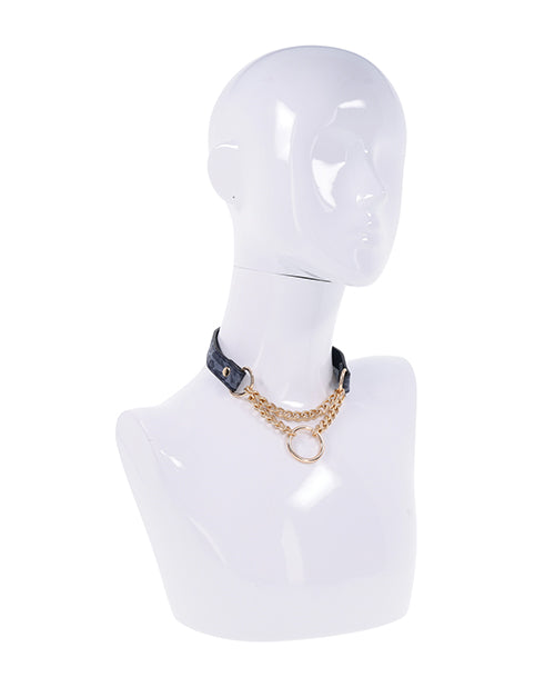A mannequin wears the Sportsheets Cougar Day Collar. The O-ring and chains hang in the front, looking like a piece of gorgeous statement jewelry in addition to being a collar. | Kinkly Shop