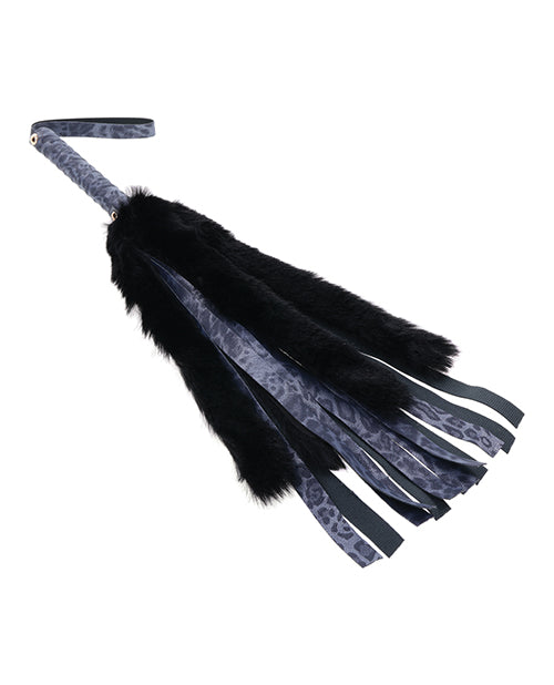 Close-up on the tails of the Sportsheets Cougar Faux Fur Flogger showcase how much longer the leather tails are than the faux fur. The leather tails are much longer than the black faux fur ones. | Kinkly Shop