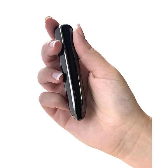 A hand holds the PowerBullet Bullet Point. It looks to be about the length of the palm of their hand (diagonally) with a width that's slightly wider than one finger. | Kinkly Shop