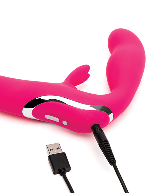 Close-up of the charger plugged into the Happy Rabbit Strapless Strap on Rabbit. It's a pin-style charger that plugs inside of the toy at the base of the toy, right underneath the wearer's insertable bulb. | Kinkly Shop
