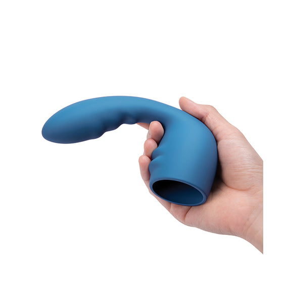 A hand holds the Le Wand Petite Flexi Attachment. The protruding insertable dildo starts with the smallest diameter near the base and gets thicker near the tip. The tip looks like it's at least 3 fingers' width. | Kinkly Shop
