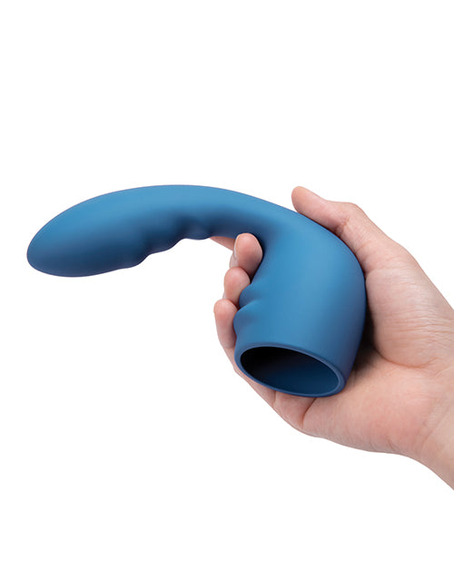 A hand holds the Le Wand Petite Flexi Attachment. The protruding insertable dildo starts with the smallest diameter near the base and gets thicker near the tip. The tip looks like it's at least 3 fingers' width. | Kinkly Shop
