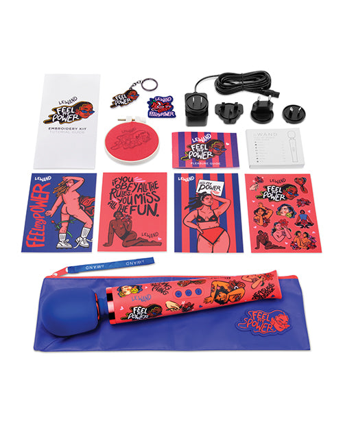 Everything included with the Le Wand Feel My Power: Kelly Malka gift set. There are stickers, postcards, keychains, instruction manuals, embroidery, a branded zipper pouch, the vibrator, and the charger with all of its international adapters. | Kinkly Shop