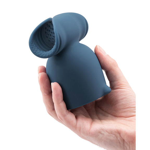 A hand holds the Le Wand Stroke Attachment. The attachment looks particularly large in their hand. | Kinkly Shop